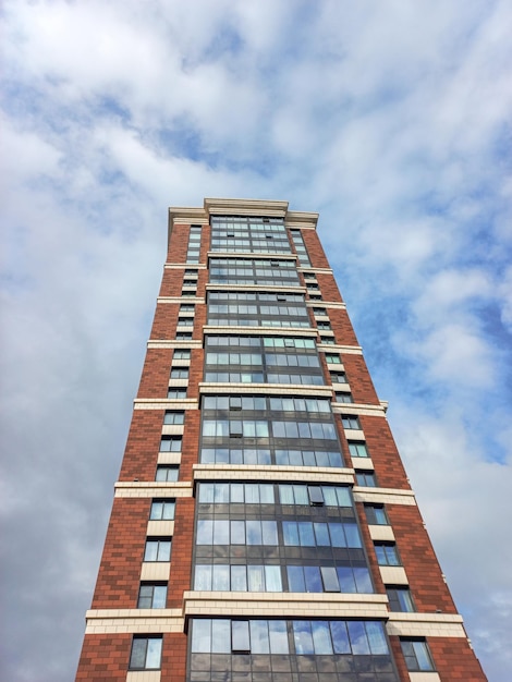 Modern beautiful new buildings Colored wall on the background of blue sky Modern construction new neighborhood Copy space vertical view