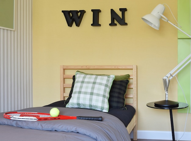 Modern bedroom interior decorative with racquet and tennis ball on wooden bed