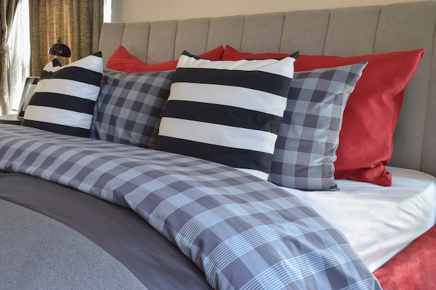 Modern bedroom interior with striped pillow on bed