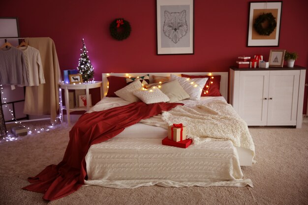 Photo modern bedroom with christmas decor and cozy double bed