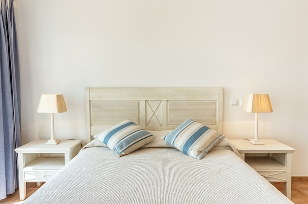 Modern bedroom with lampshades, photographed frontally.