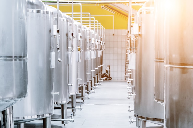 Modern Beer Factory. Steel tanks for storage and fermentation of beer. Sunlight effect