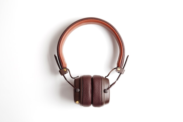 Modern brown leather wireless headphones isolated on white