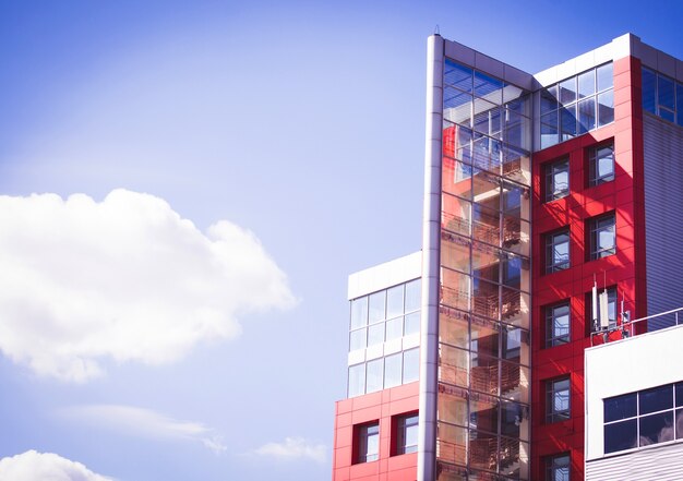 Modern building on a background of blue sky with clouds