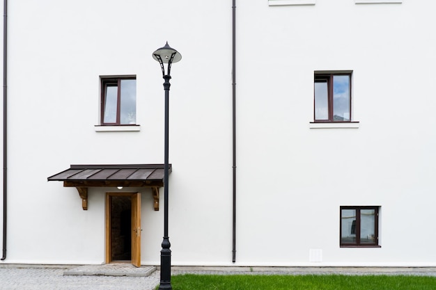 Modern building design house in concrete white with large windows and green lawn