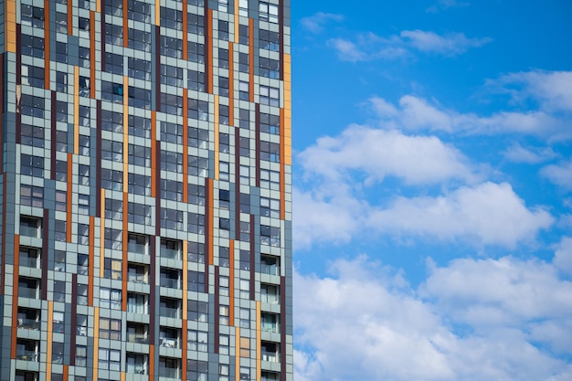 Modern Building facade white clouds on the blue sky