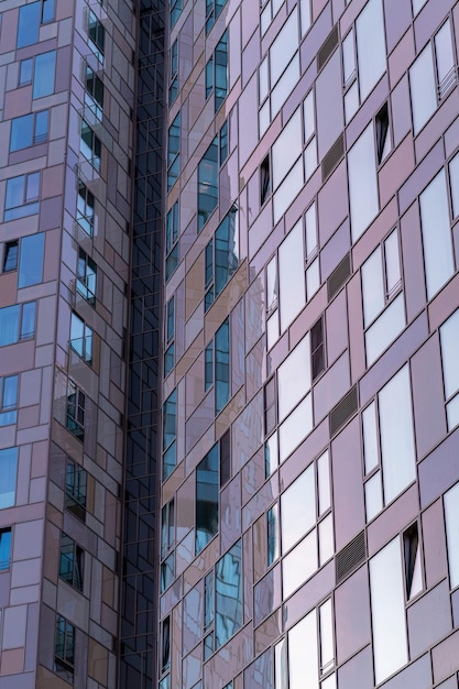 Modern building wall with sunset light reflection on windows