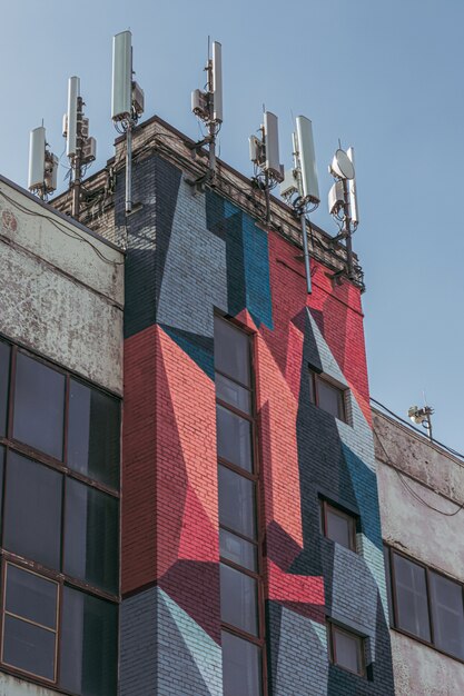 Modern building with graffiti and antennas.