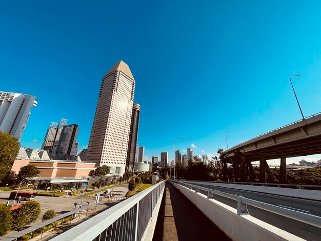 Modern buildings against clear blue sky in city