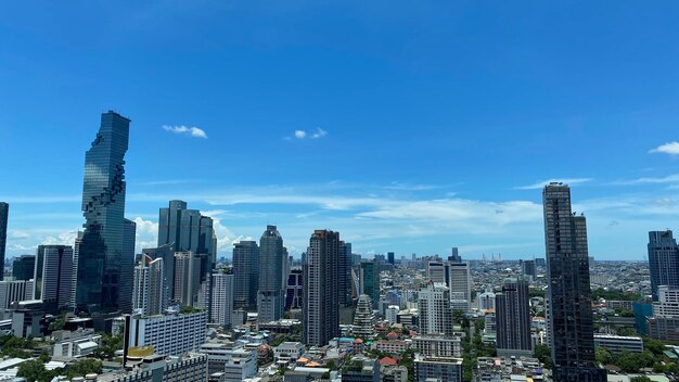 Modern buildings in city against blue sky