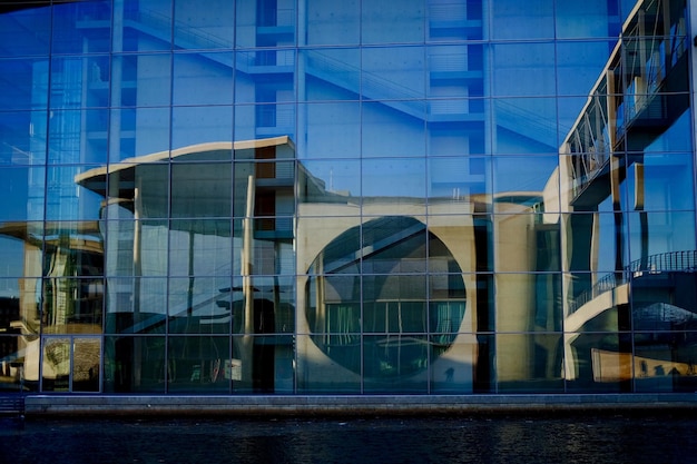 Modern buildings in city against blue sky