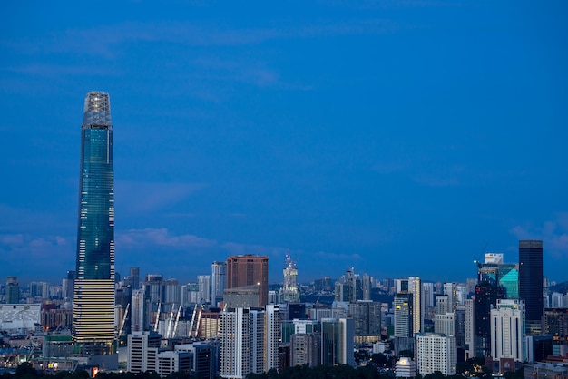 Modern buildings in city against blue sky