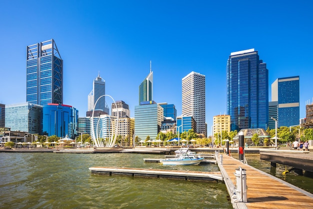 Modern buildings in city against clear blue sky