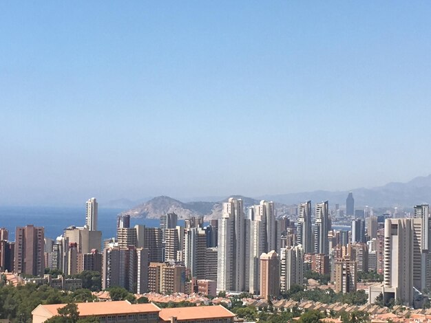 Modern buildings in city against clear sky