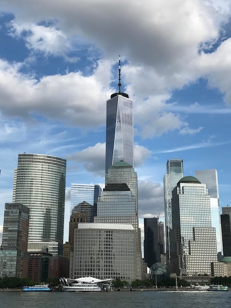 Modern buildings in city against cloudy sky