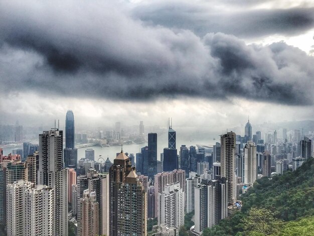 Modern buildings in city against cloudy sky