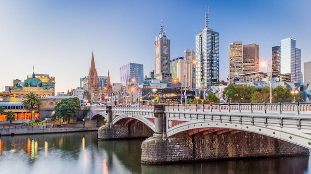 Photo modern buildings in front of yarra river against clear sky at dusk