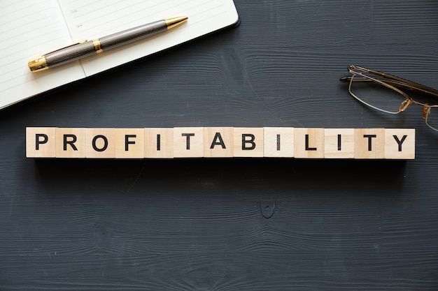 Modern business buzzword - profitability. Top view on wooden table with blocks. Top view.