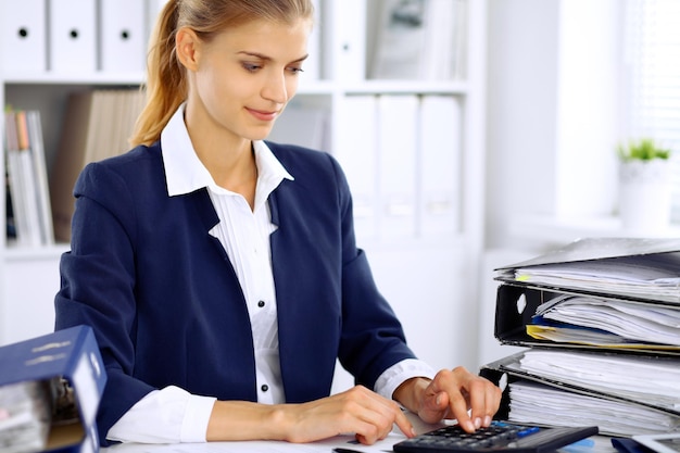 Modern business woman or confident female accountant in office