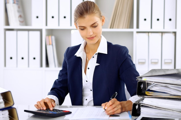 Modern business woman or confident female accountant in office.