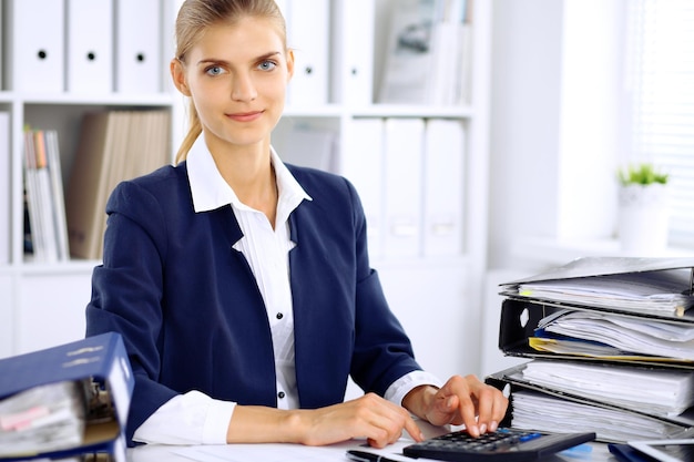 Modern business woman or confident female accountant in office.