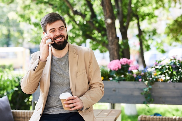 Modern Businessman Enjoying Phone Conversation Outdoors