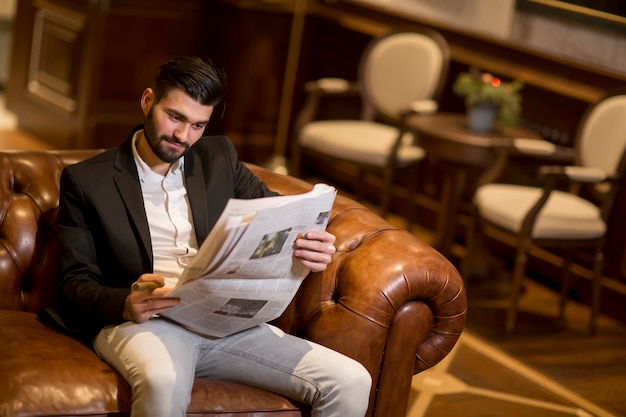 Modern businessman reading newspapers