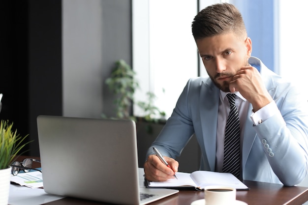 Modern businessman thinking about something while sitting in the office.