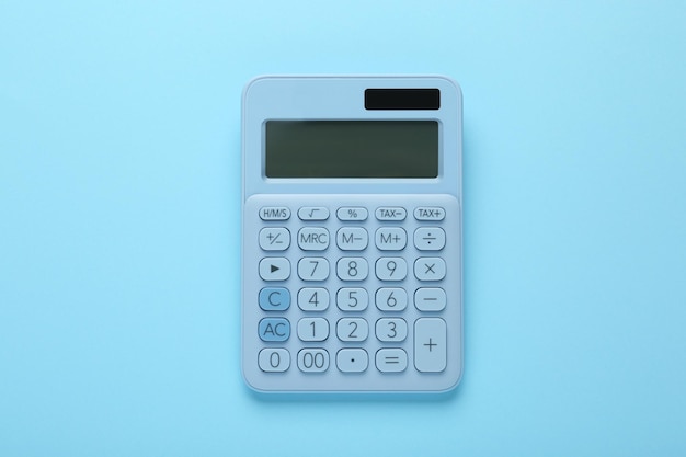 Modern calculator on light blue background top view