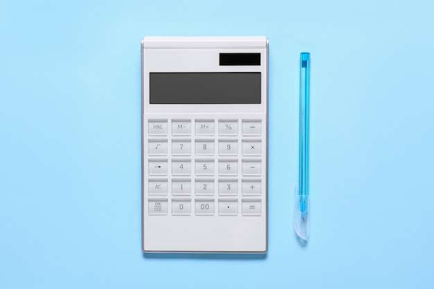 modern calculator and pen on color surface