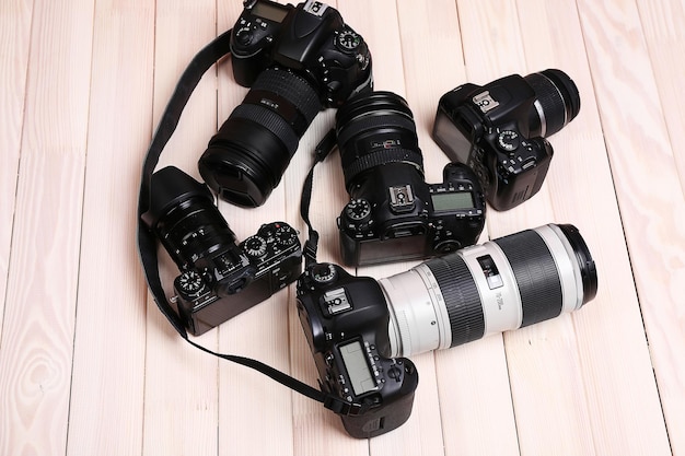 Modern cameras on wooden background