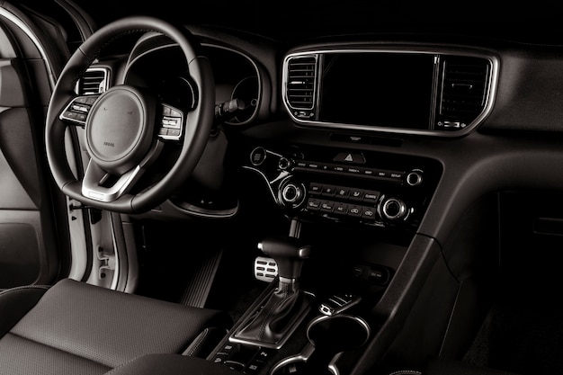 Modern car interior, automatic gearbox, steering wheel, and dashboard