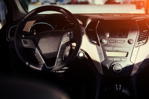 Modern car interior dashboard and steering wheel.