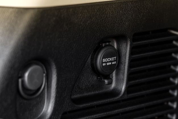 Modern car outlet socket. Closed 12V power outlet socket.