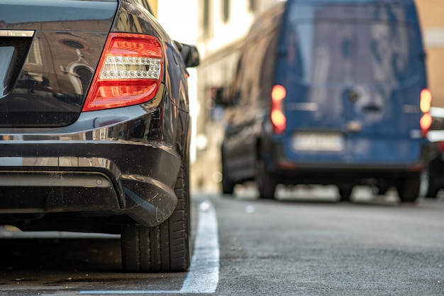 Modern cars parked on city street side