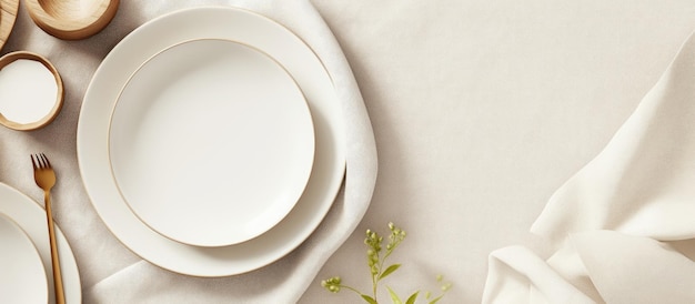 Modern ceramic tableware viewed from above on a white linen tablecloth with room for text Stylish