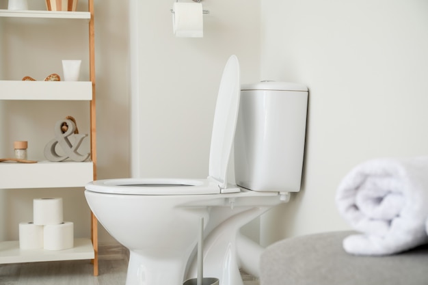 Modern ceramic toilet bowl in interior of restroom