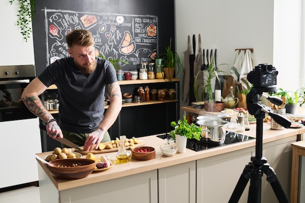 Modern Chef Cutting Potatoes At Kitchen