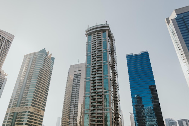 Modern city skyscrapers buildings at sunset time with business and residential towers around a lake