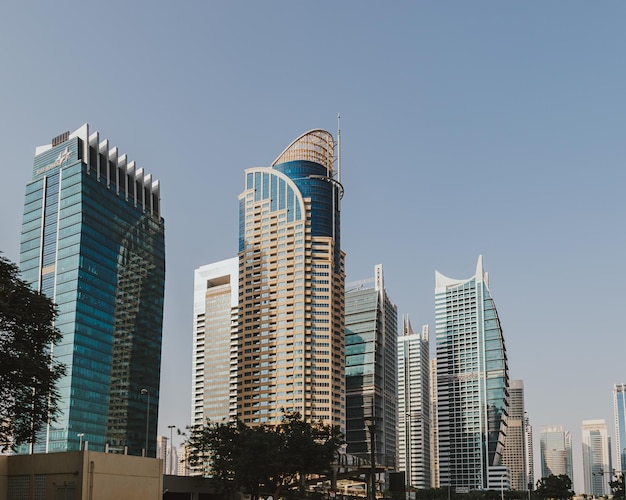 Modern city skyscrapers buildings at sunset time with business and residential towers around a lake