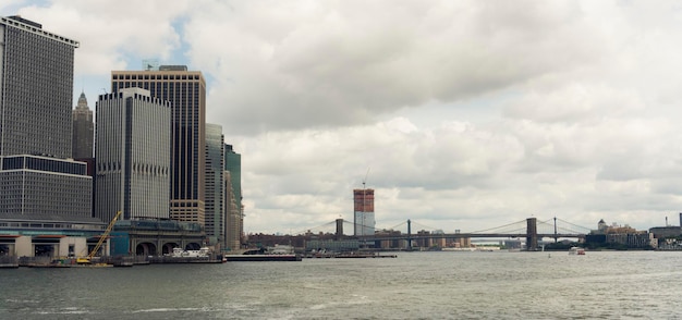 Modern cityscape by sea against sky