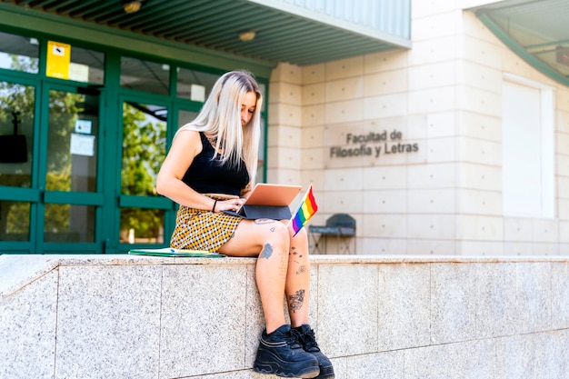 Modern college girl with LGTBI flag studying at the college