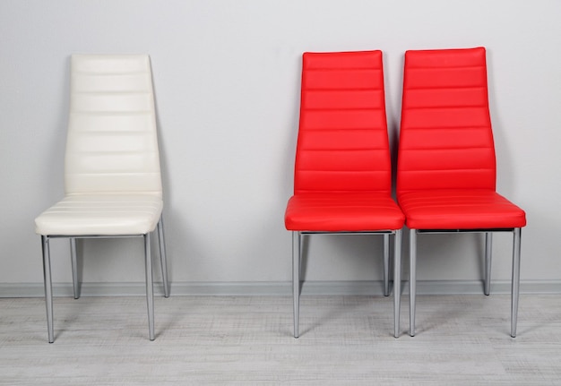 Modern color chairs on wall background