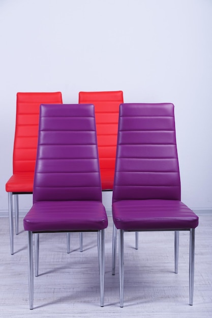 Modern color chairs on wall background