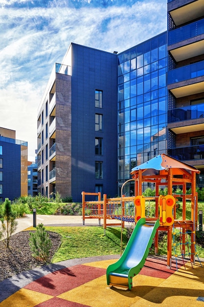 Modern complex of apartment residential buildings and children playground. With outdoor facilities.