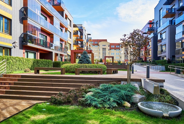 Modern complex of apartment residential buildings and decorative water fountain. With outdoor facilities.