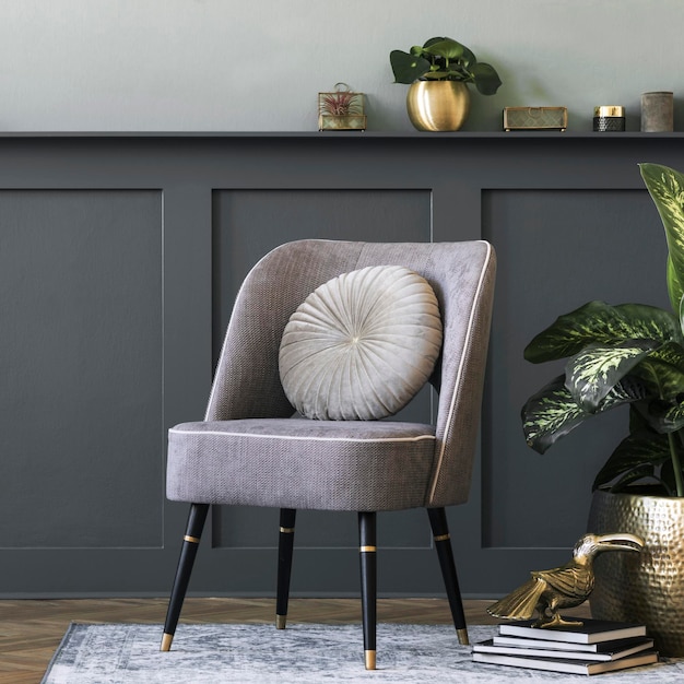 Modern composition of living room with design gray armchair\
gold pot with beautiful plant books and elegant personal\
accessories gray wall panelling with shelf stylish home staging\
template