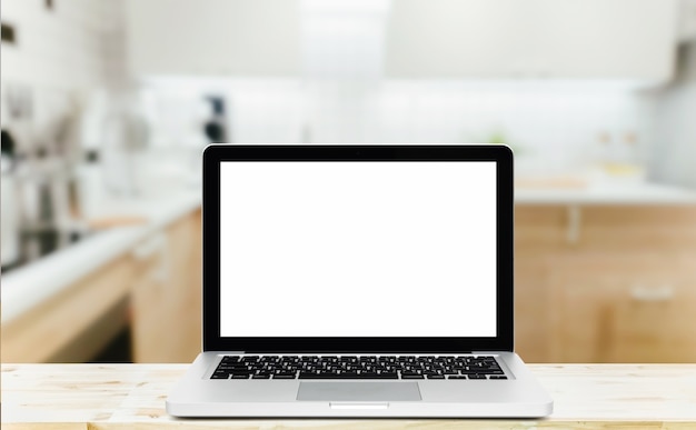 Modern computer,laptop with blank screen on wood table top on blurred kitchen background