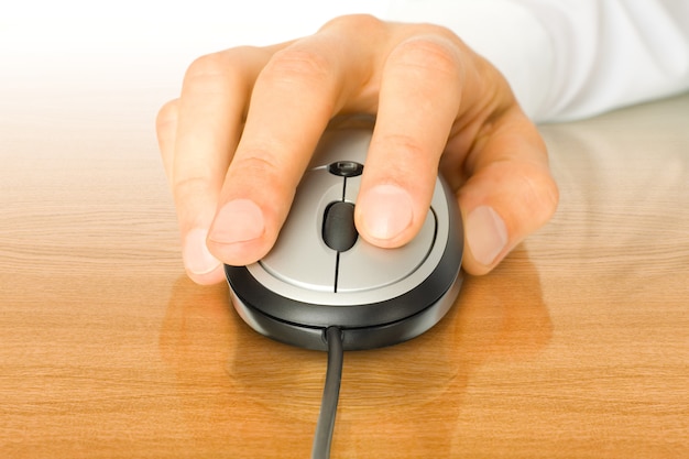 Modern computer mouse with hand over table