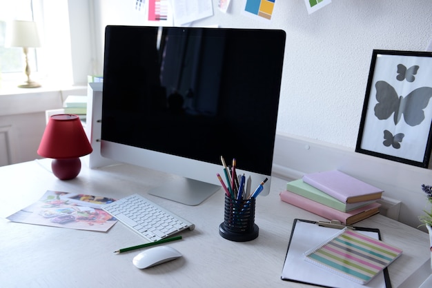 Modern computer on the table in decorated room